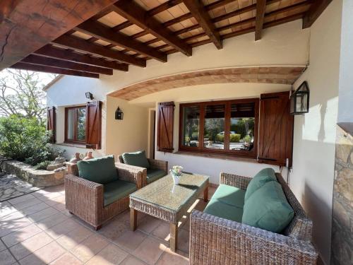 an outdoor patio with wicker furniture and a table at Torre Vella 66 in Torroella de Montgrí