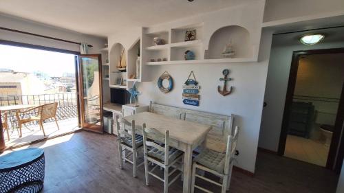 a dining room with a table and chairs and a balcony at La Font Lovely apartment LEstartit 400 meter from the beach in L'Estartit