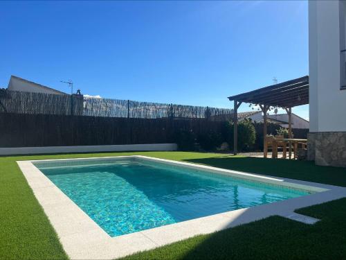 a swimming pool in a yard with a fence at Alemanya 38 in Torroella de Montgrí