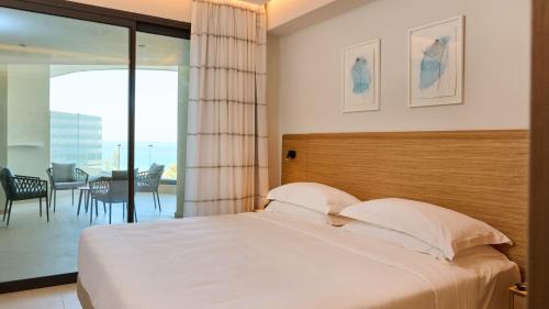 a bedroom with a bed and a view of the ocean at Sunrise Emerald in Protaras