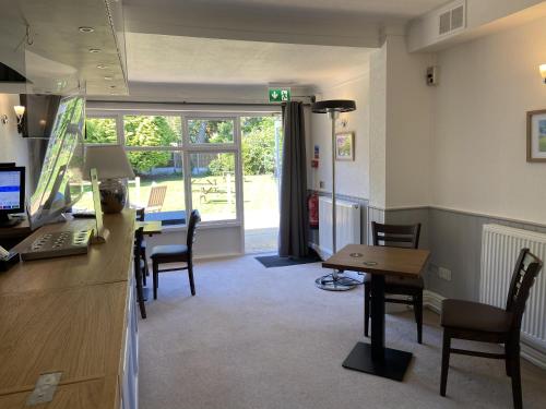 an office with a desk with a computer and chairs at Old Farm Hotel in Birmingham