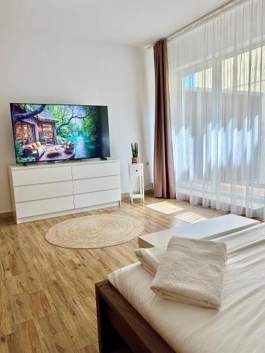 a bedroom with a bed with a flat screen tv at Central Loft Studio Târgoviște in Târgovişte
