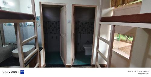 an open bathroom with a toilet and a sink at The Rail Coach in Jhānsi