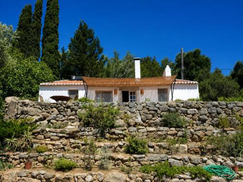 a house behind a stone wall at Casalinho do Farol, Serra da Arrábida in Setúbal