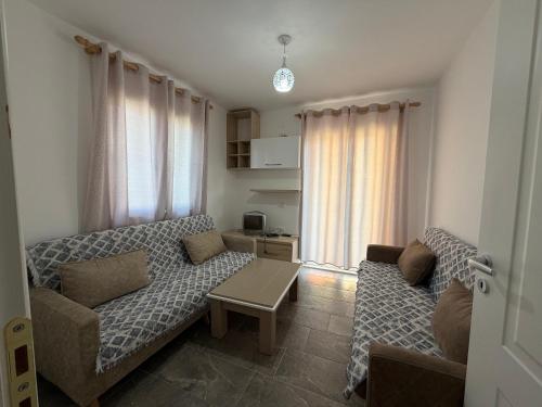 a living room with a couch and a table at Guest House Central Vlora in Vlorë