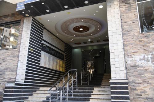 a building with stairs in front of a building at Doma Hotel Matrouh in Marsa Matruh