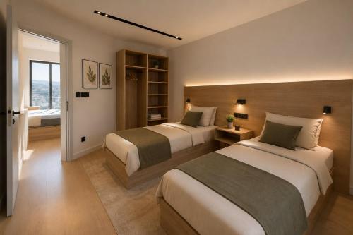 a bedroom with two beds and a window at wifad Hotel in Al Namas