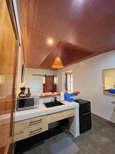 a kitchen with a sink and a microwave at Republika Beach Resort in San Juan