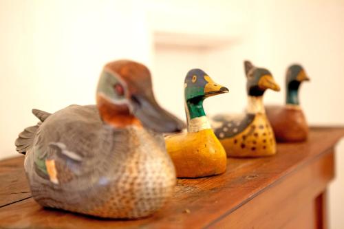 a group of rubber ducks sitting on a wooden table at Engels Landhaus Suite in Mörbisch am See