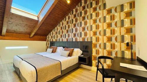 a bedroom with a bed and a desk in a room at Soho Boutique La Harinera in Valladolid