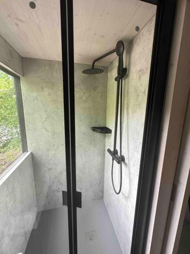 a shower in a bathroom with a glass door at Posed v korunách stromů in Kutná Hora