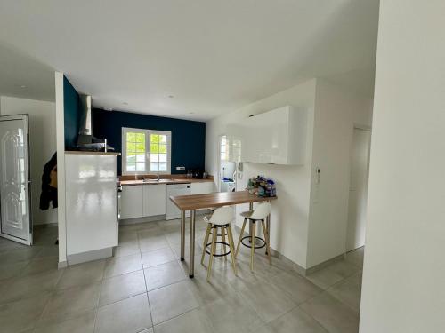 a kitchen with a table and some stools in it at La Couronne Apartment in La Couronne