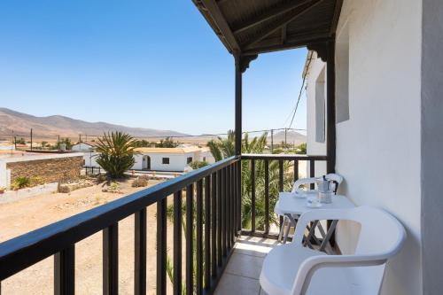 a balcony with a table and a view of the desert at Home2Book Las Tinajas A, Peaceful Retreat in Triquivijate