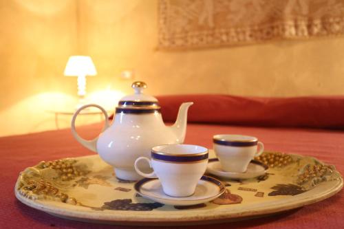a tea set on a tray with two cups on a table at Molino del Rotone in Buti