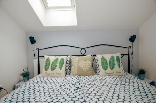 a bedroom with a bed with pillows on it at MarAzul Apartments in Povljana
