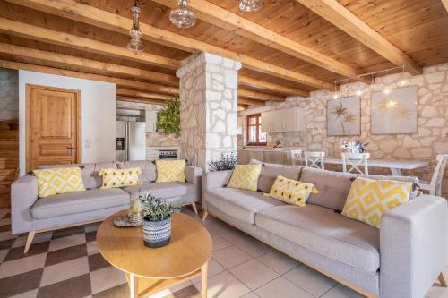 a living room with couches and a table at Nephele 3 bedroom villa with private pool in Akrotiri