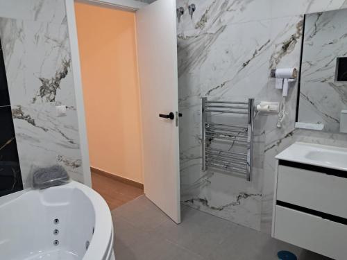 a bathroom with a white toilet and a sink at HC Home in Algeciras