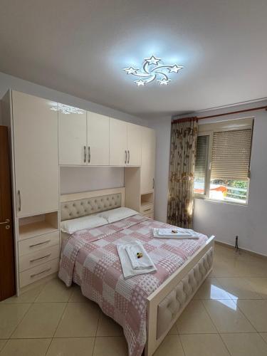 a bedroom with a bed with a towel on it at Emily House in Fier