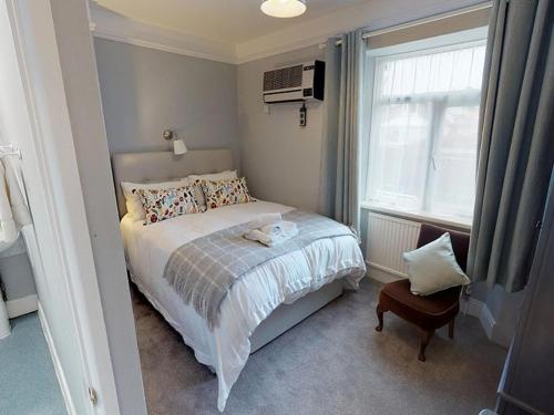 a small bedroom with a bed and a window at Ranscombe House in Brixham