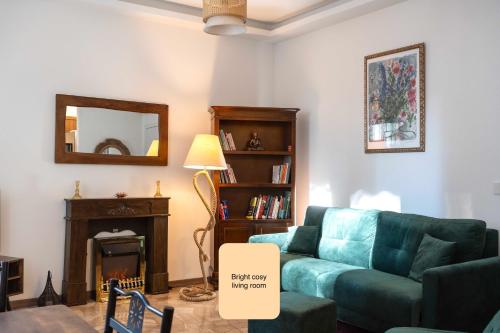 a living room with a blue couch and a mirror at Charming king appartment with balcony and jacuzzi in Como