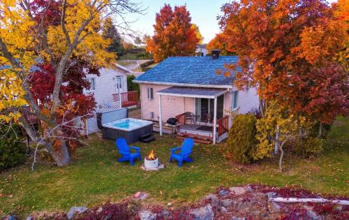 an aerial view of a backyard with chairs and a fire at Chalet Studio #3 Waterfront with Spa, Fireplace & Wifi in Cap-Saint-Ignace
