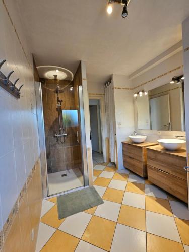 a bathroom with two sinks and a shower at Les Renaudelles in Angles
