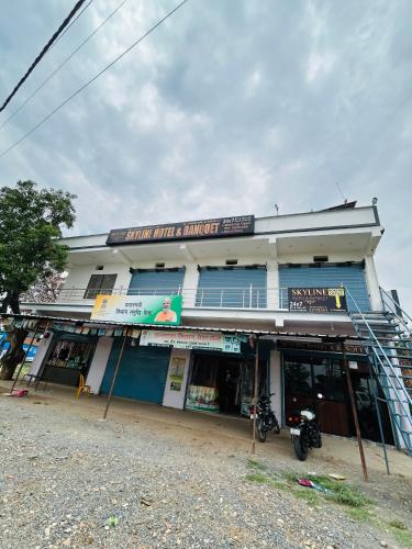 a building with a motorcycle parked in front of it at Skyline Hotel & Banquet in Rewa