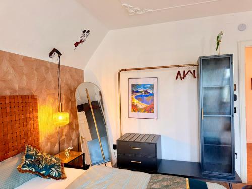 a bedroom with a bed and a dresser and a mirror at CASA Salzburg in Salzburg