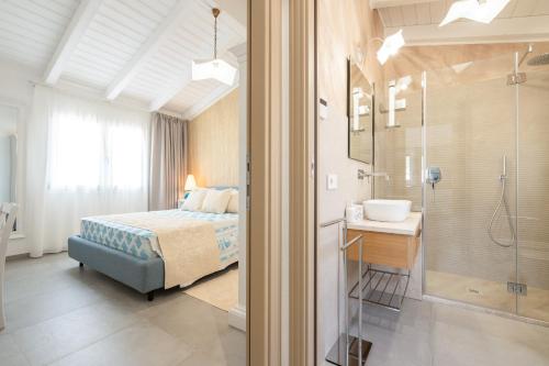 a bedroom with a bed and a shower and a sink at Borgo Myricae in Chia