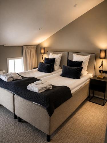 a bedroom with two beds with pillows on them at Marstrands Kurhotell in Marstrand
