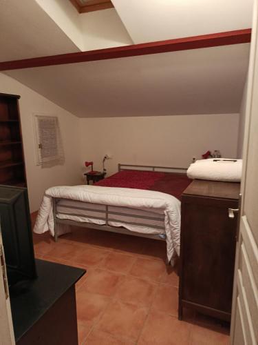 a bedroom with a bed and a tv in it at Appartement Mugron in Mugron