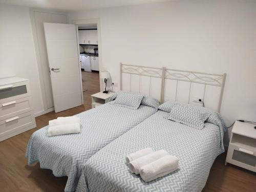a bedroom with a large bed with two pillows on it at La casa de Carmen in Neda