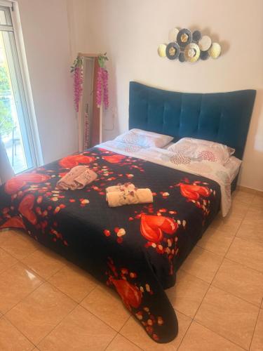 a bedroom with a bed with a blue head board at B&Bapartment in Arta
