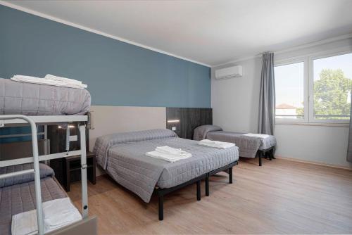 a room with two bunk beds and a table at Urban Hotel in Cesena