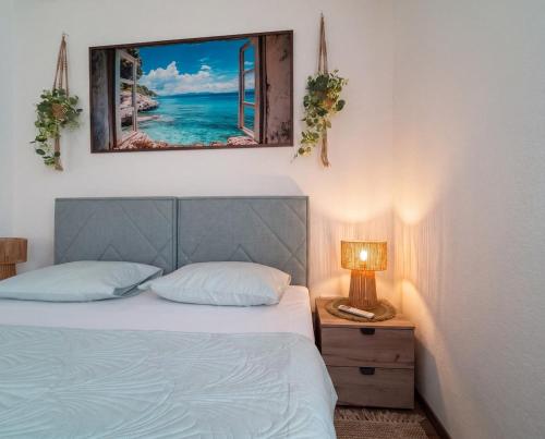 a bedroom with a bed and a picture of the ocean at Villa Aurea Luxury Sunset with Pool in Krimovice