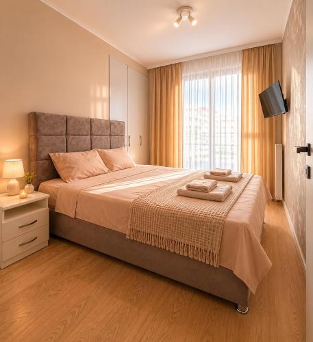 a bedroom with a large bed and a window at Aria Lux Belgrade Waterfront in Belgrade