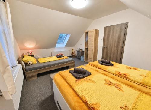 a bedroom with two beds and a couch at Podbrdská chalupa in Nechanice