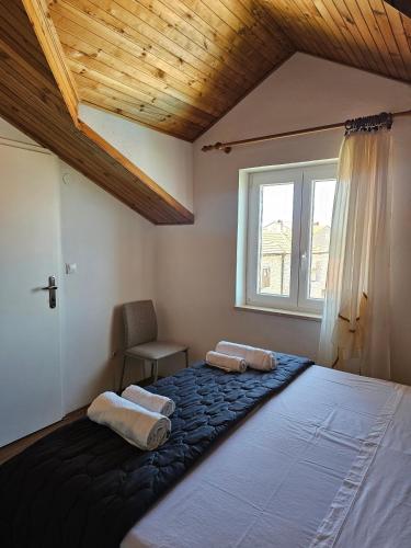 a bedroom with a large bed and a window at Apartmani Banić Apartman 4 in Postira