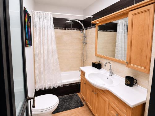 a bathroom with a white sink and a toilet at Olympus B&B in Mitzpe Ramon
