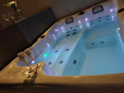 a bathroom with a tub with lights in it at Prestigious & Modern SeaView Penthouse with Private Jacuzzi in Marsaskala