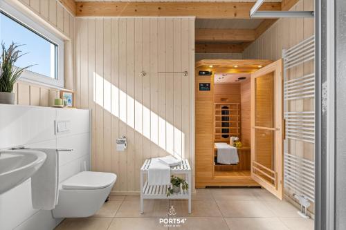 a bathroom with a toilet and a sink at Ferienhaus Südheide Olpenitz in Olpenitz