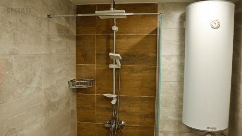 a shower with a glass door in a bathroom at Orehite-Family Hotel ,Food & Pool in Bozhichen
