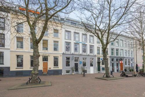 a large white building with trees in front of it at hotel emma next in Rotterdam