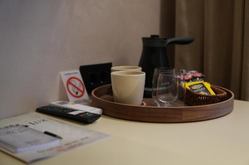 a tray with a coffee maker and glasses on a table at Central Lux in Petrovac na Mlavi