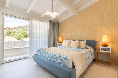 a bedroom with a bed and a large window at Borgo Myricae in Chia