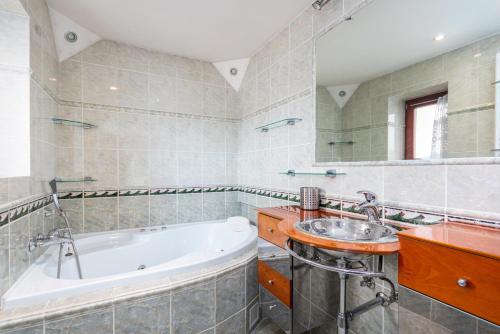 a bathroom with a tub and a sink at Byty Na vyhlídce in Zdice