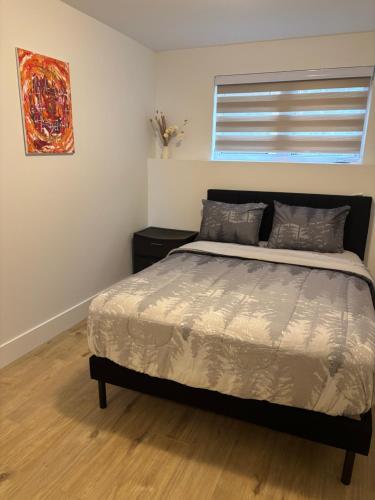 a bedroom with a bed and a window at La perle de Dieppe in Dieppe