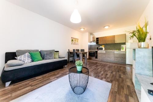 a living room with a couch and a table at Nova City Apartments in Budapest