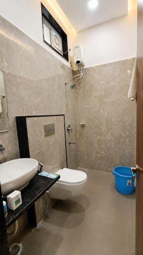 a bathroom with a toilet and a sink at Harsh Pushp Garden in Raipur