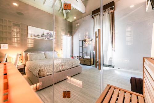 a bedroom with a bed and a glass wall at Boutique Casa Giulietta Desenzano in Desenzano del Garda
